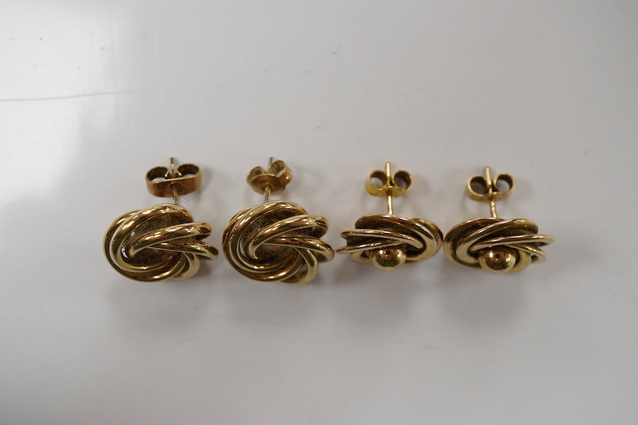 Two pairs of 9ct gold stud earrings, each of knot design, each pair 1.5cm diameter, post fittings, British hallmarks, combined gross weight 9 grams